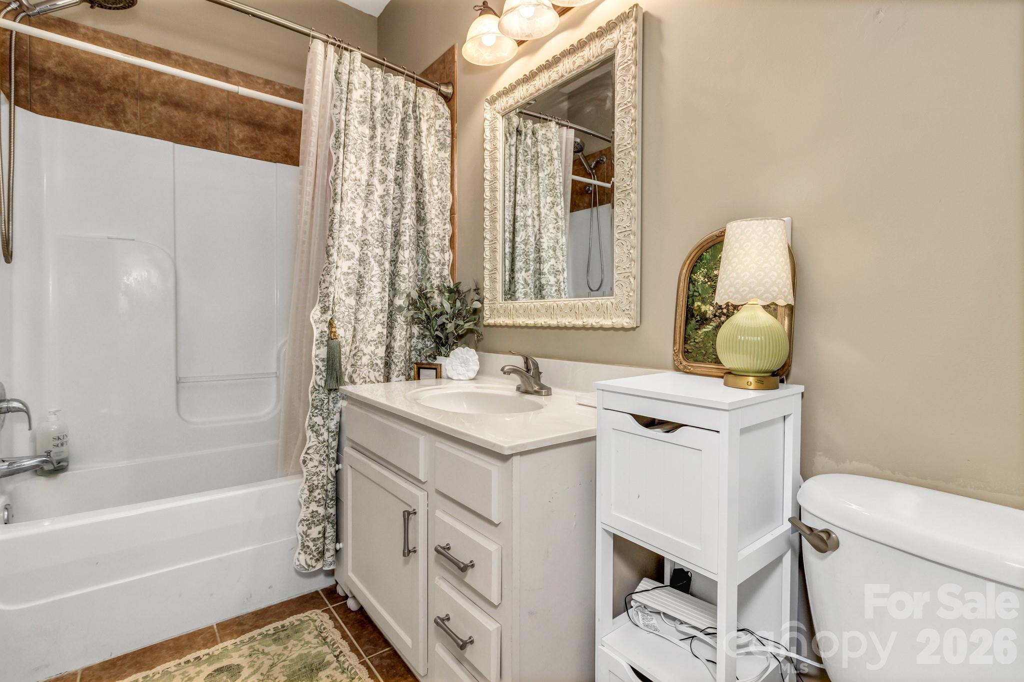 25 Union Chapel Road Weaverville, NC 28787 - Photo 30 of 47 a bathroom with a granite countertop sink a toilet and shower