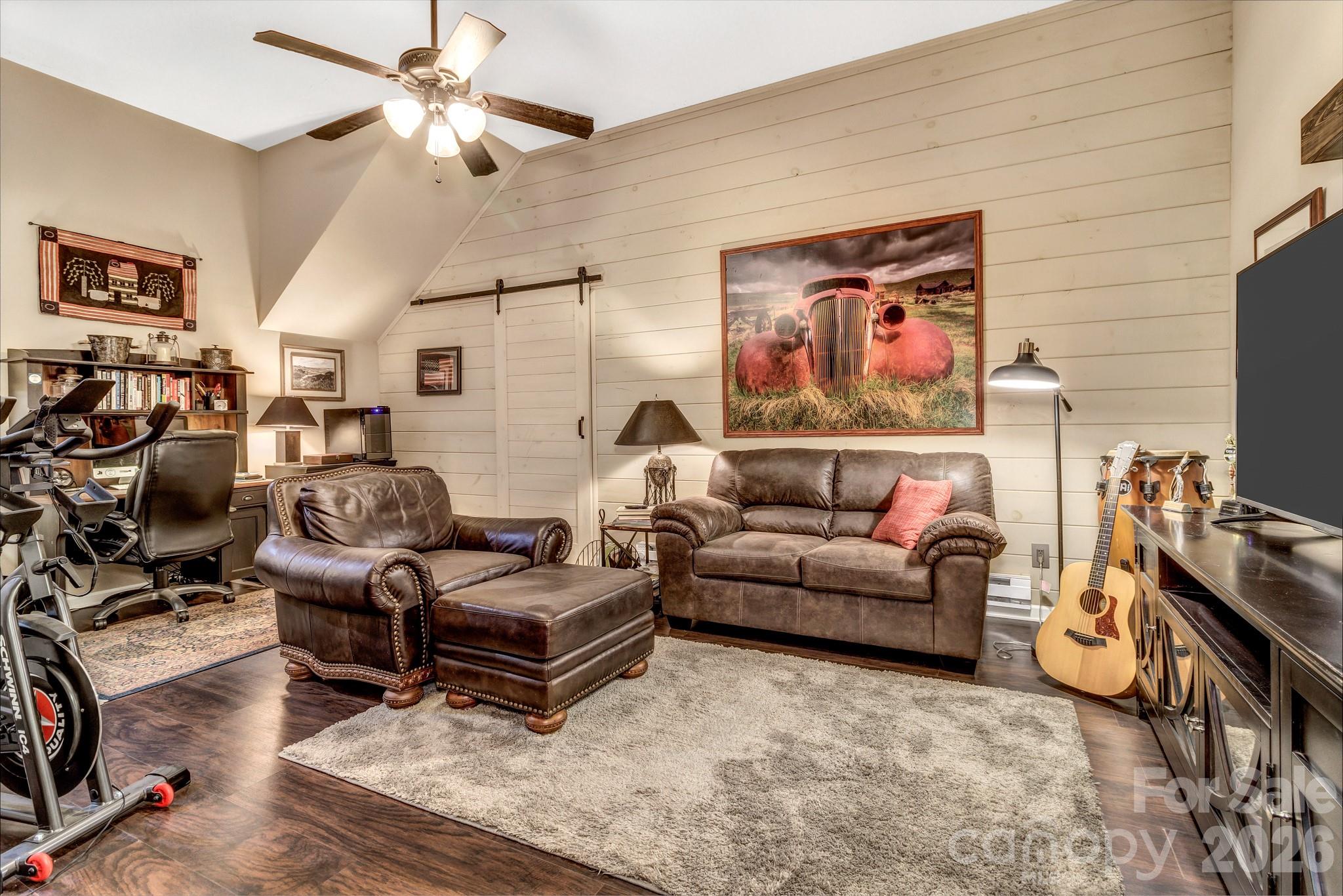 25 Union Chapel Road Weaverville, NC 28787 - Photo 35 of 43 a living room with furniture a couch and a flat screen tv