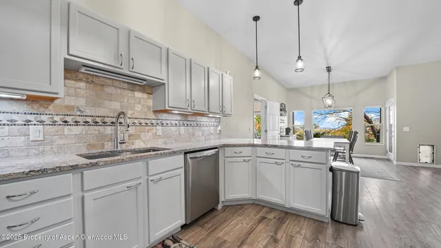 a kitchen with sink cabinets and wooden floor