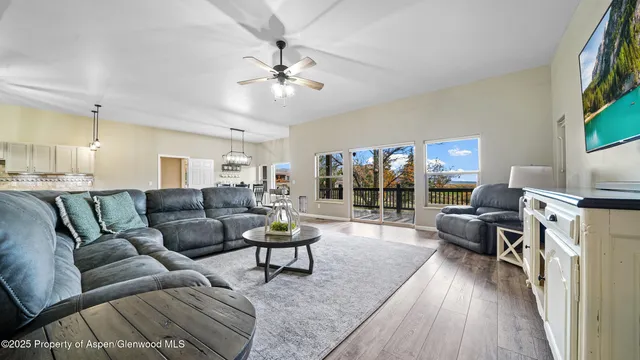 a living room with furniture and a chandelier