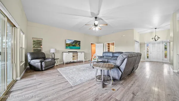 a living room with furniture and a wooden floor
