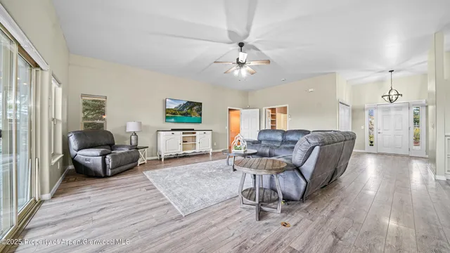 a living room with furniture and a wooden floor