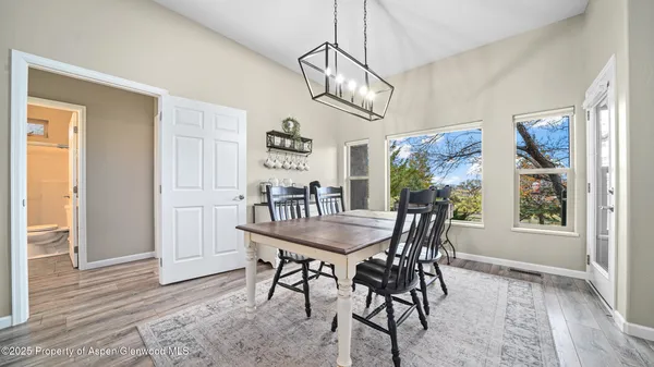 a view of a dining room with furniture window and wooden floor