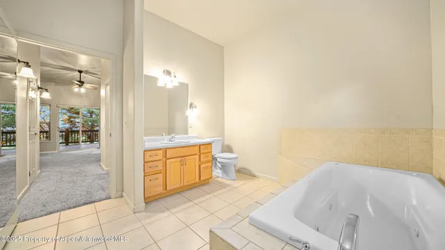 a spacious bathroom with a granite countertop sink mirror and a