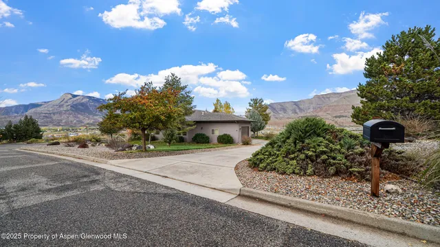 a front view of a house with a yard and garden