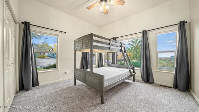 a bed room with a bed and a chandelier