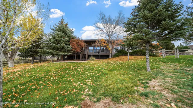 a view of a house with a backyard
