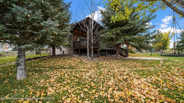 a front view of a house with a tree