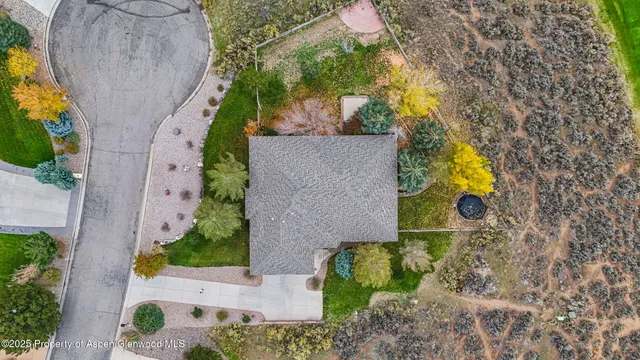 an aerial view of a house with a yard and a garden