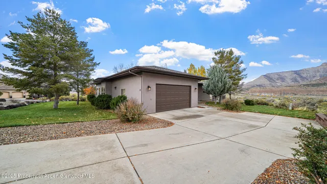 a yellow house with trees in front of it