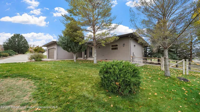 a house that has a tree in front of it