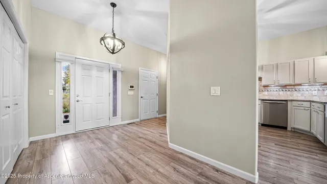 a view of a room with wooden floor