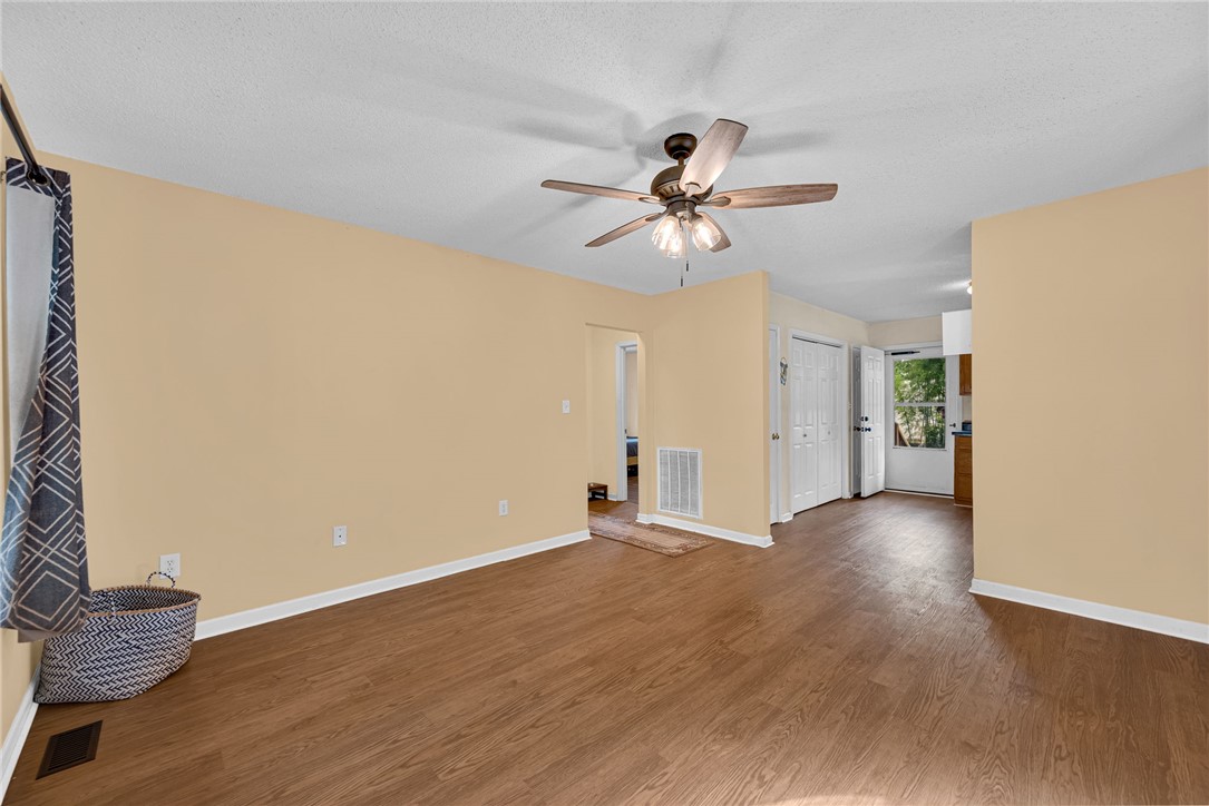 1020 Elizabeth Street Anderson, SC 29624 - Photo 4 of 22 A welcoming interior space featuring durable laminate flooring and an overhead ceiling fan for comfort.