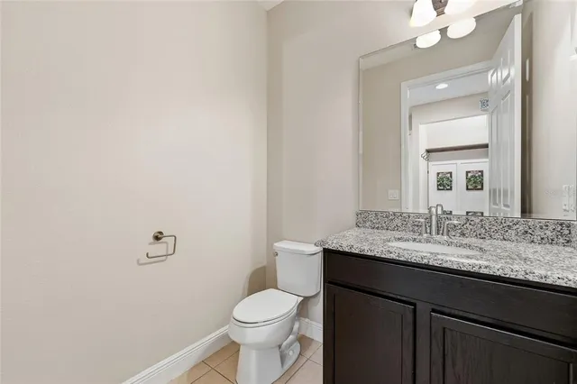 a spacious bedroom with a bed and a painting on the wall