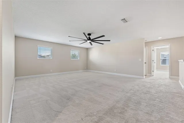 a spacious bathroom with a tub sink and mirror