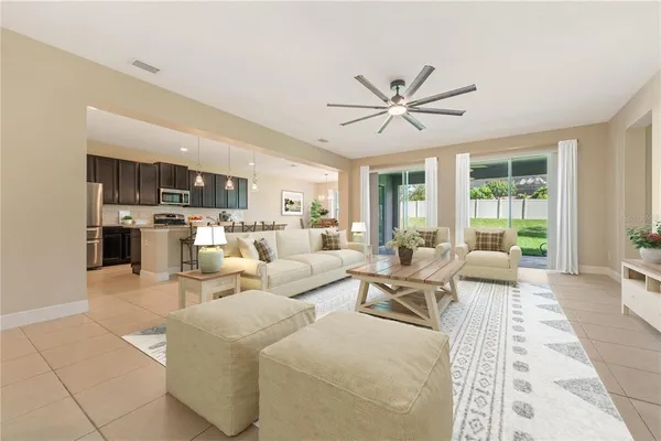 a living room with furniture ceiling fan and a rug