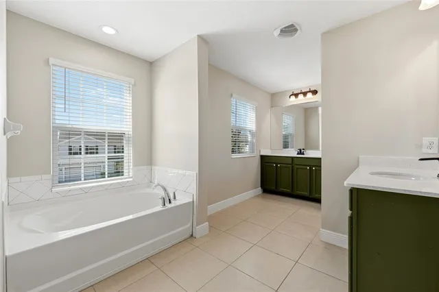 an empty room with a window and a ceiling fan