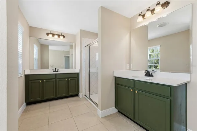 an empty room with a ceiling fan and windows