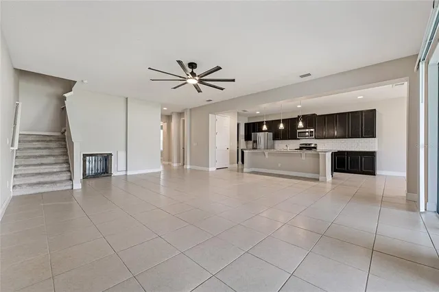 a view of a livingroom with a kitchen counter top space and appliances