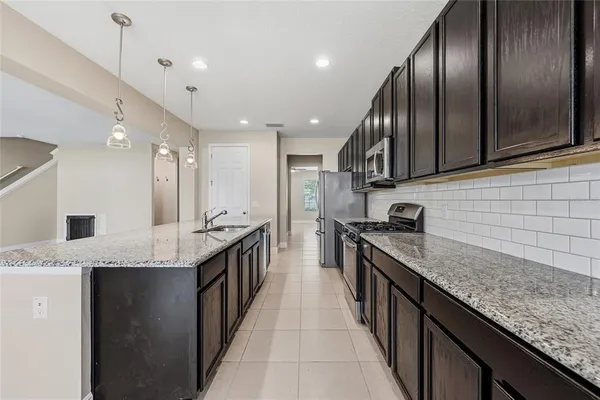 a kitchen with granite countertop stainless steel appliances and a sink