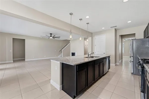 a kitchen with a sink a counter top space stainless steel appliances and cabinets