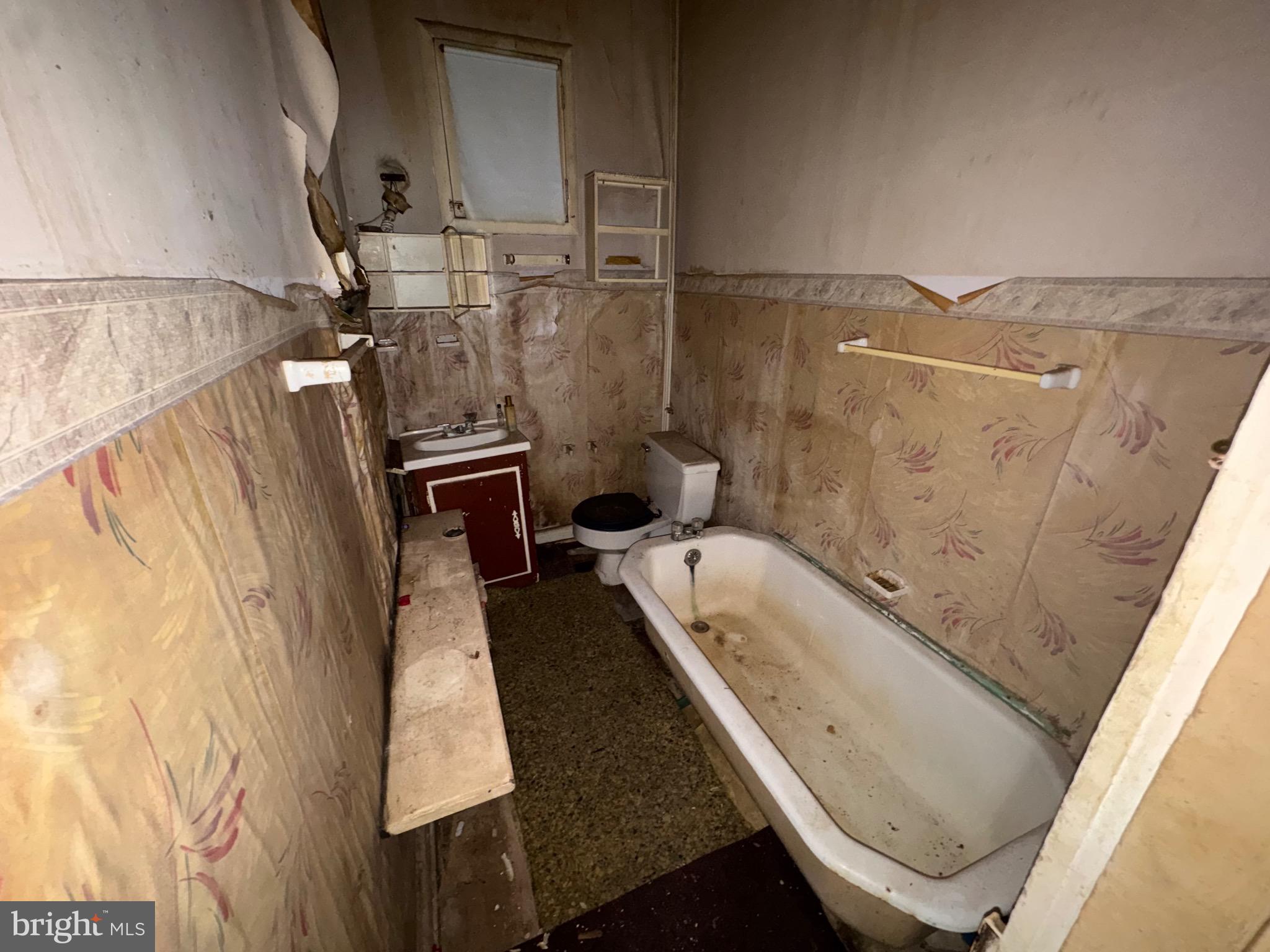 105 North Fulton Avenue Baltimore, MD 21223 - Photo 12 of 38 a bathroom with a tub sink and toilet