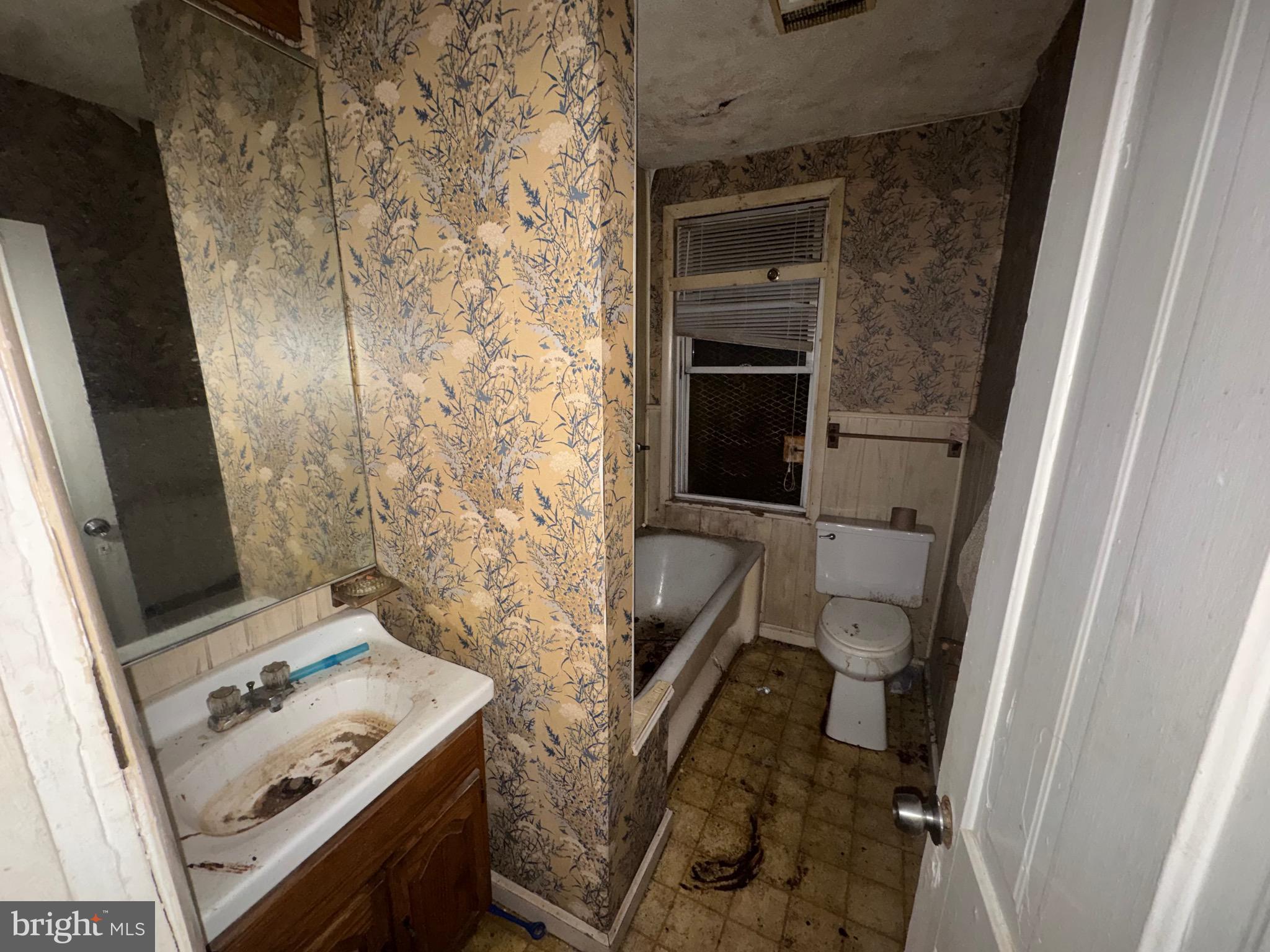 105 North Fulton Avenue Baltimore, MD 21223 - Photo 21 of 38 a bathroom with a toilet and a sink