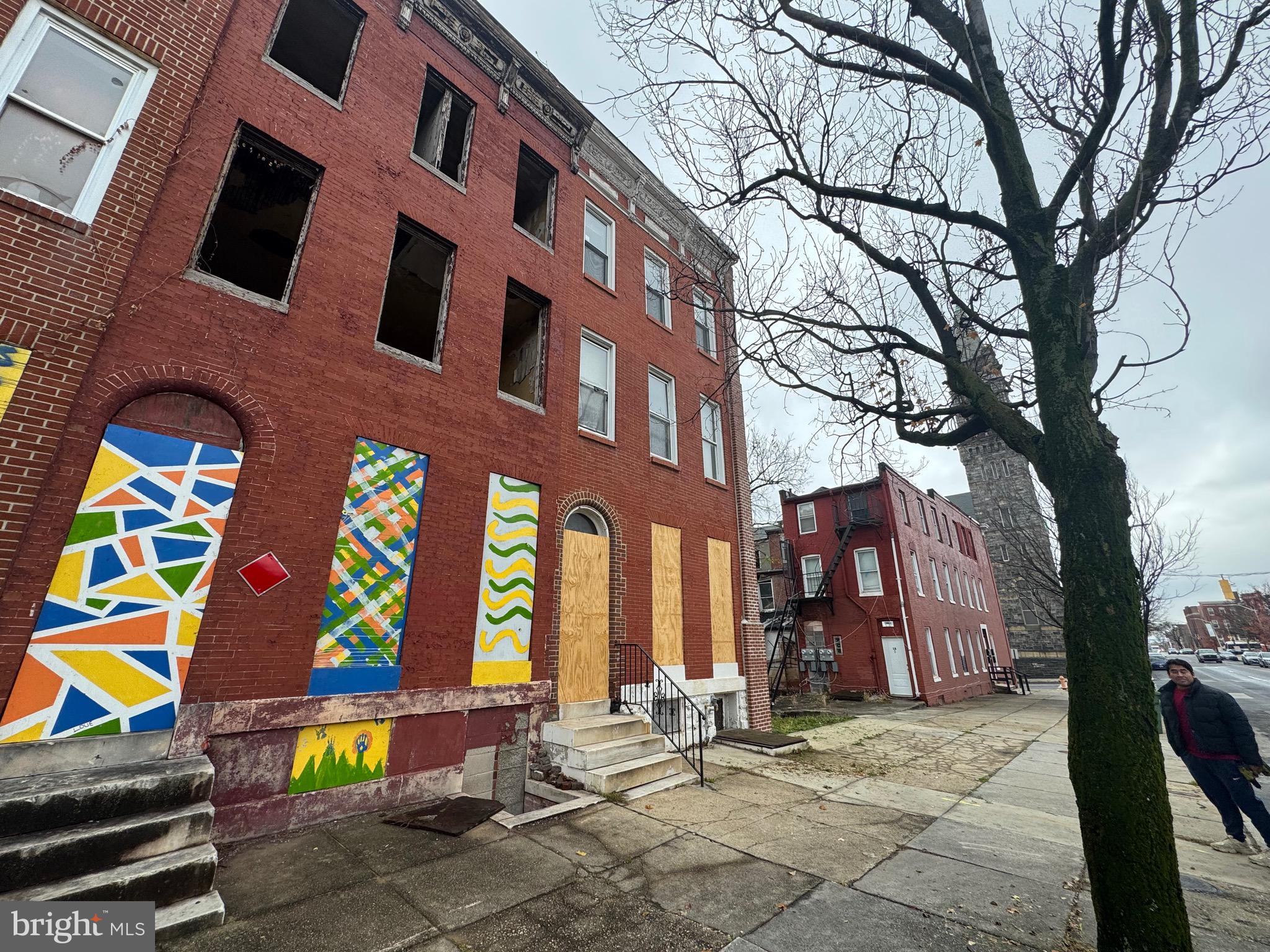 105 North Fulton Avenue Baltimore, MD 21223 - Photo 3 of 38 a view of a brick building with a tree in front