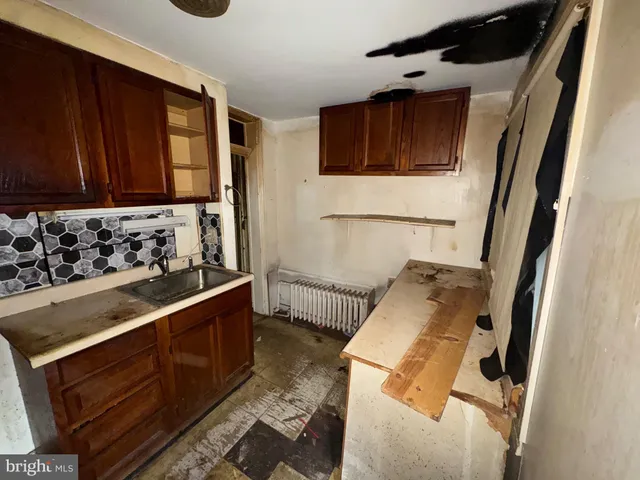 a kitchen with wooden cabinets and a stove top oven
