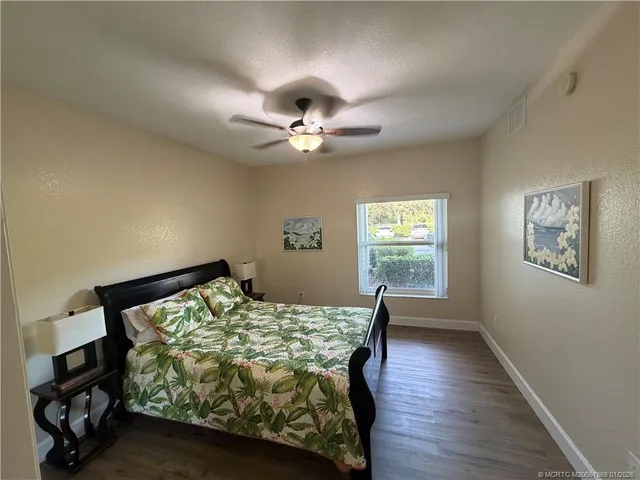 a bedroom with furniture window and a ceiling fan