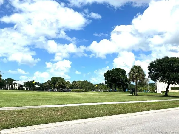 a view of a golf course with trees