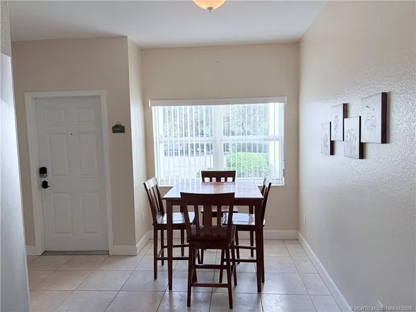 a dining room with furniture and window