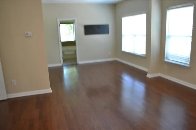 a view of a house with brick walls and a tree