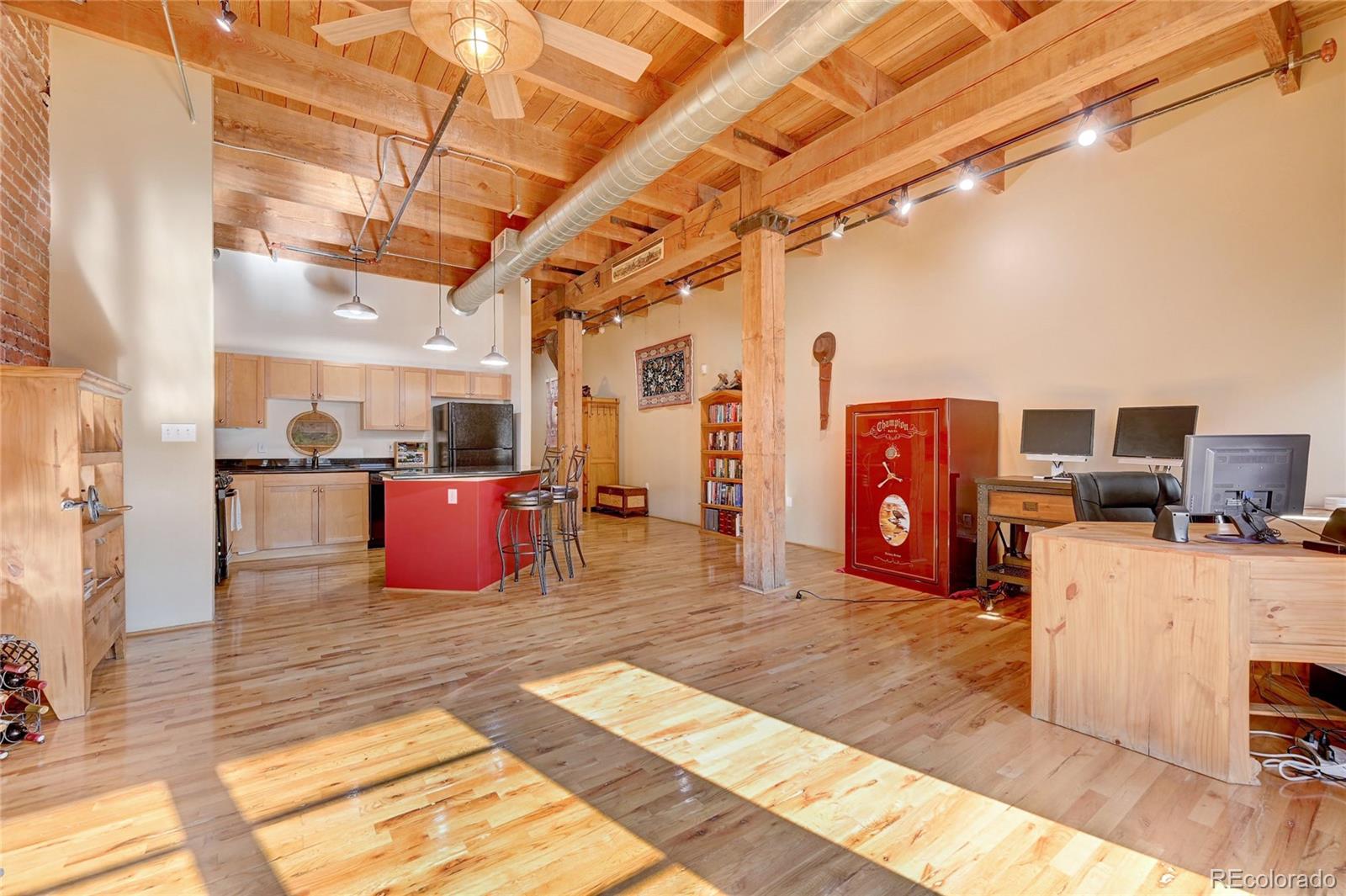 2960 Inca Street, Unit 313 Denver, CO 80202 - Photo 12 of 27 a large room with lots of appliances and a chandelier