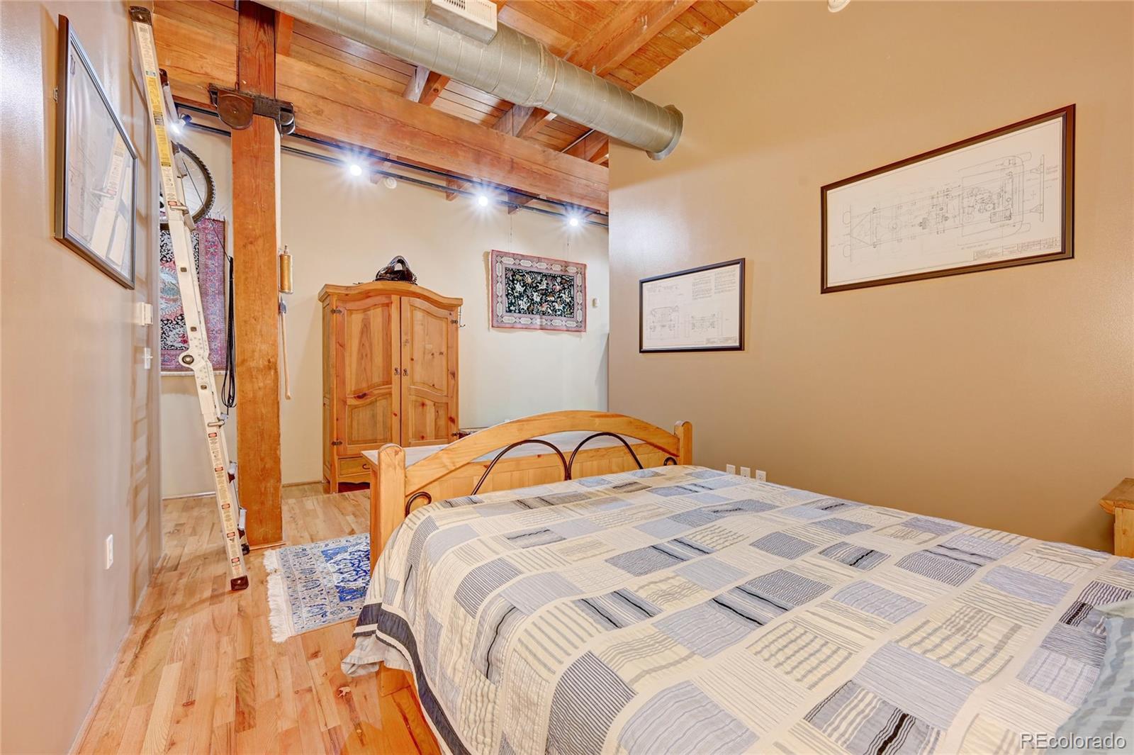 2960 Inca Street, Unit 313 Denver, CO 80202 - Photo 15 of 27 a bedroom with a bed and a dresser