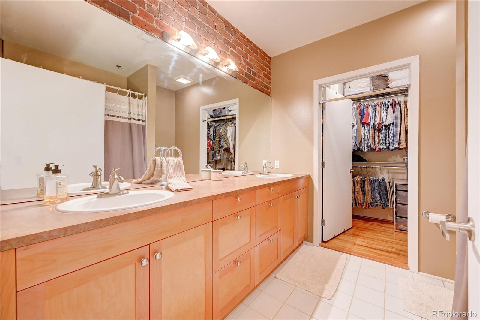 2960 Inca Street, Unit 313 Denver, CO 80202 - Photo 17 of 27 a bathroom with a sink and a mirror