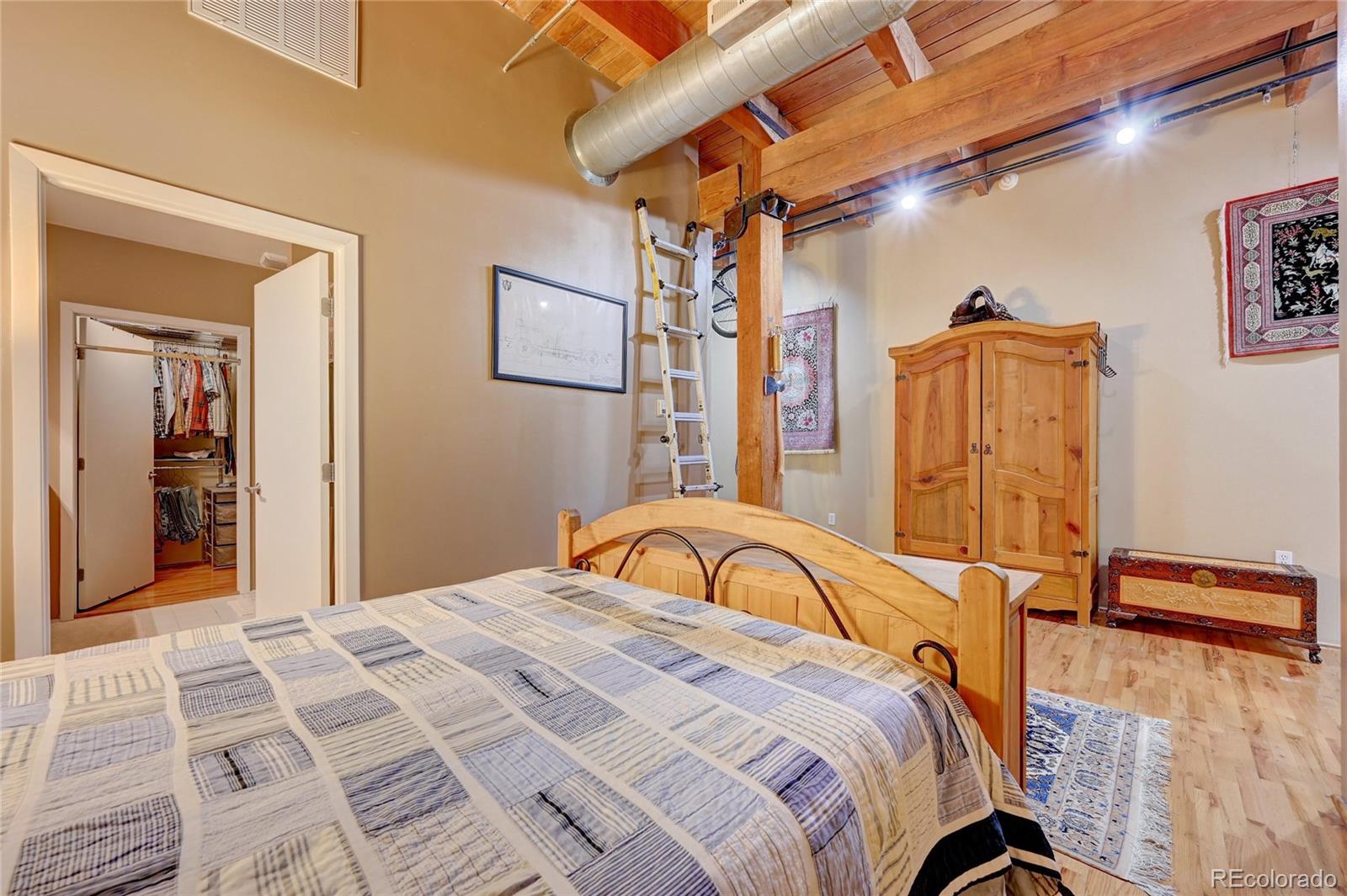 2960 Inca Street, Unit 313 Denver, CO 80202 - Photo 18 of 27 a bedroom with a bed and a mirror