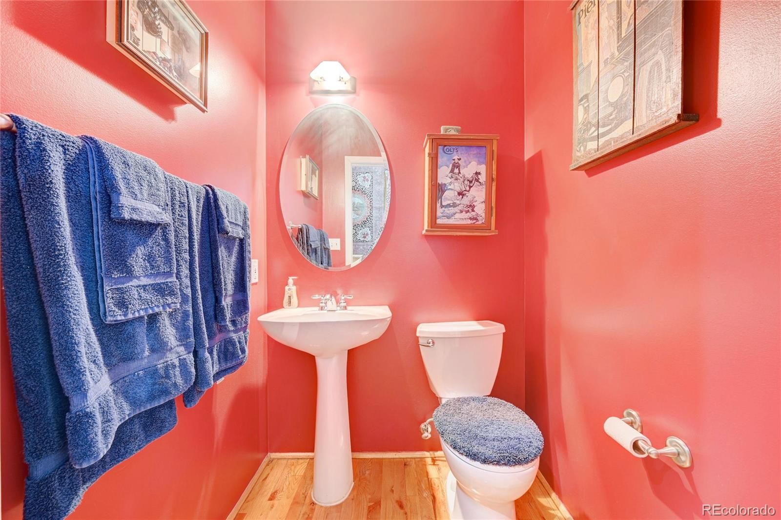 2960 Inca Street, Unit 313 Denver, CO 80202 - Photo 20 of 27 a bathroom with a toilet mirror and vanity