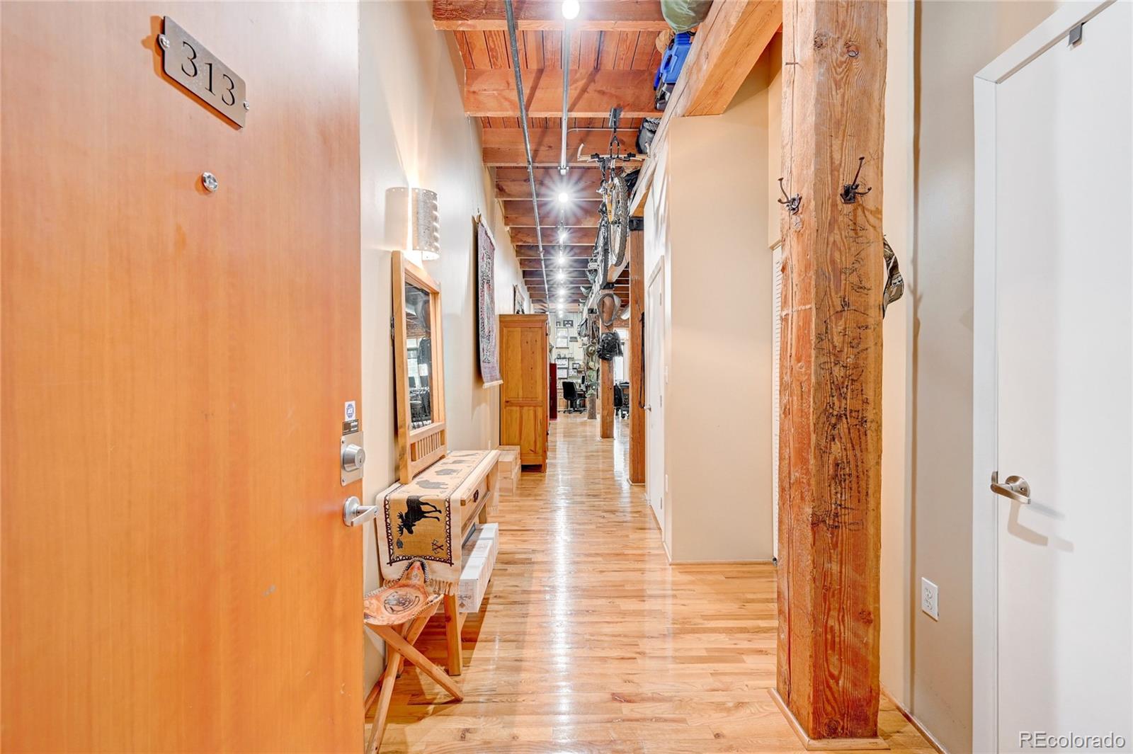 2960 Inca Street, Unit 313 Denver, CO 80202 - Photo 2 of 27 a view of a hallway with wooden floor