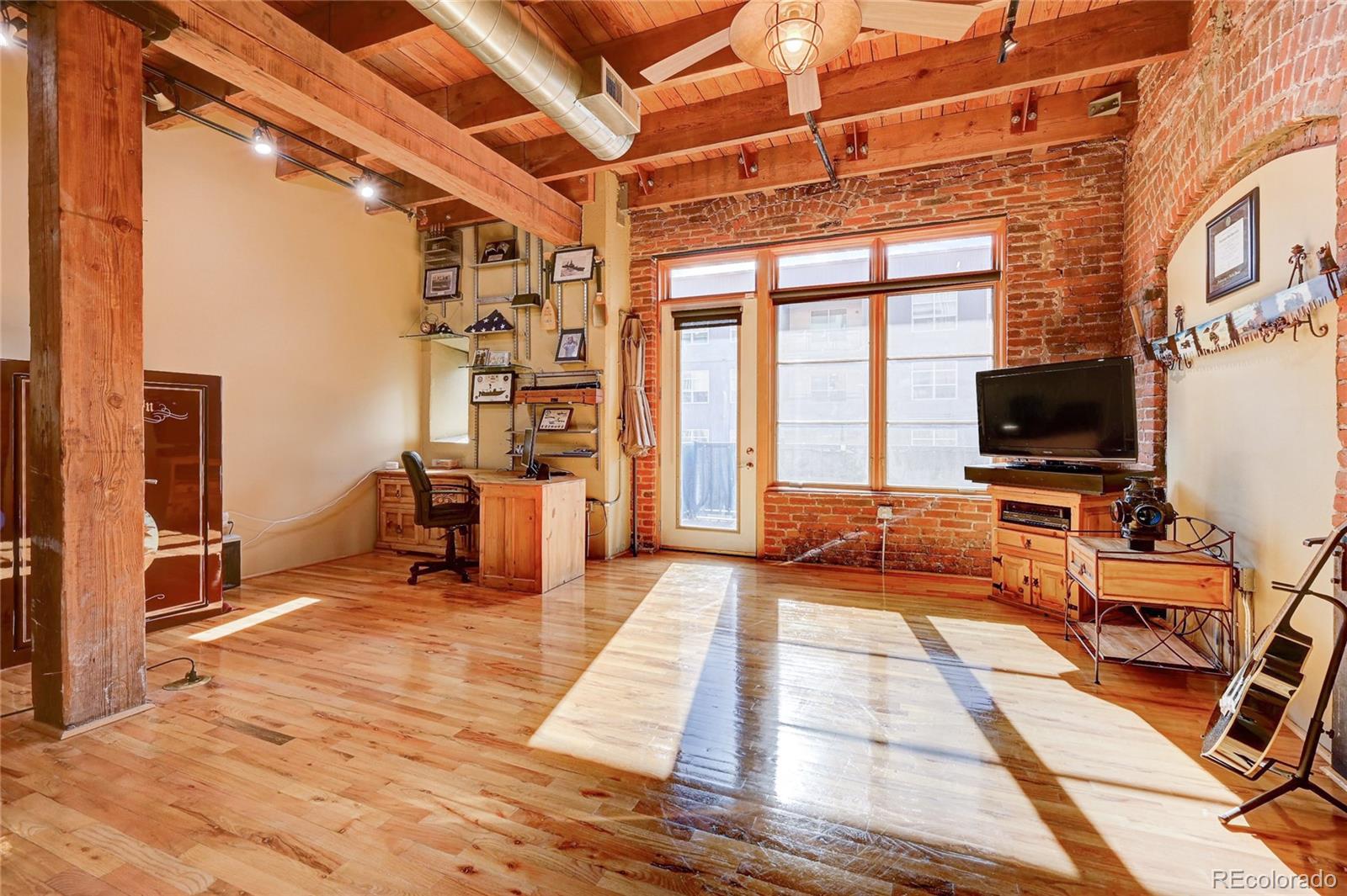 2960 Inca Street, Unit 313 Denver, CO 80202 - Photo 9 of 27 a living room with patio furniture and a flat screen tv