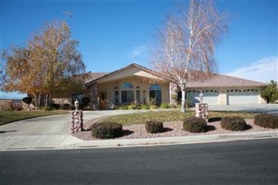12786 Quail Summit Road Apple Valley, CA 92308 - Photo 1 of 1 a front view of a house with a yard
