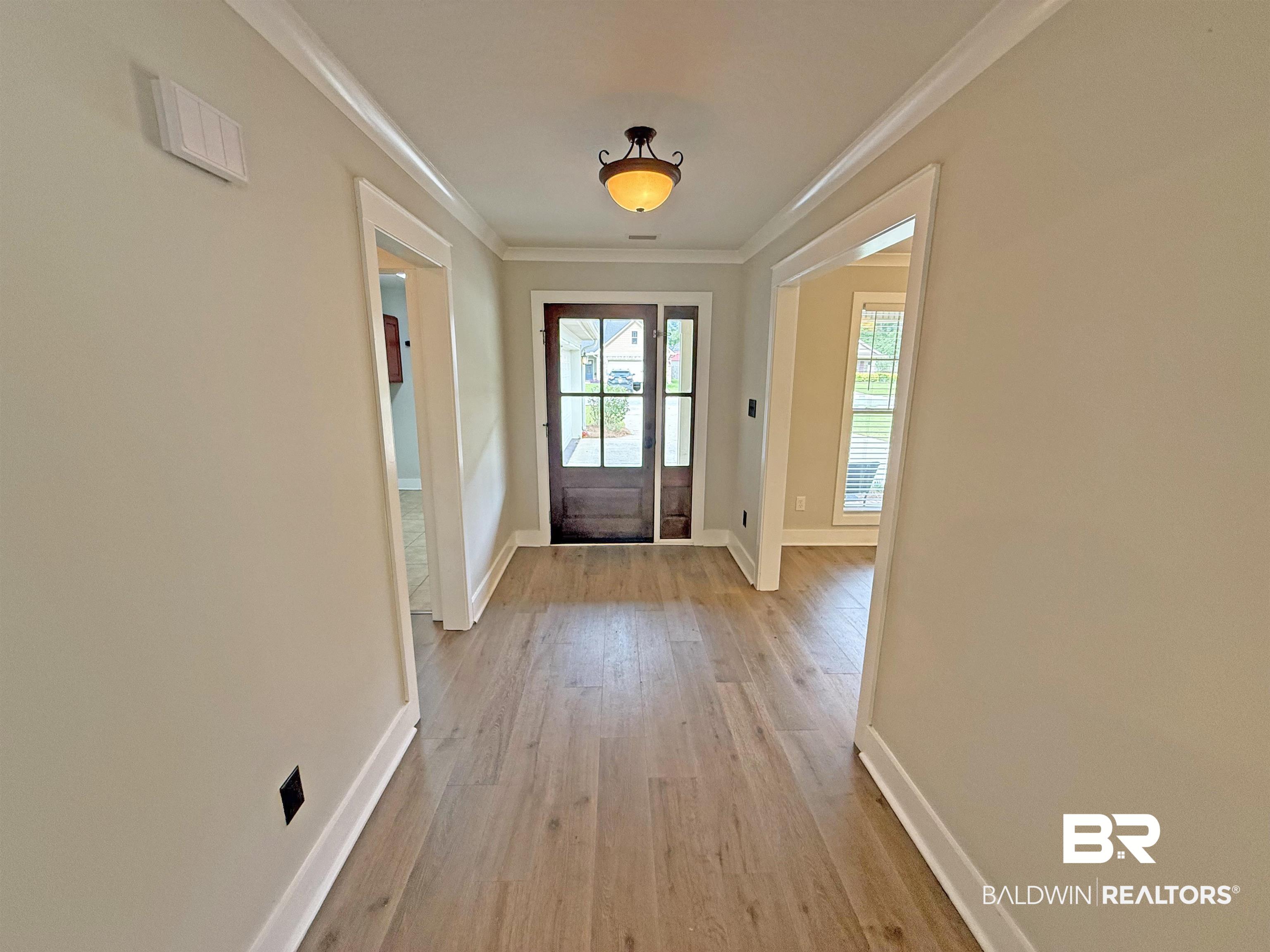 22023 Garland Loop Silverhill, AL 36576 - Photo 2 of 33 Doorway featuring ornamental molding and light wood-style floors