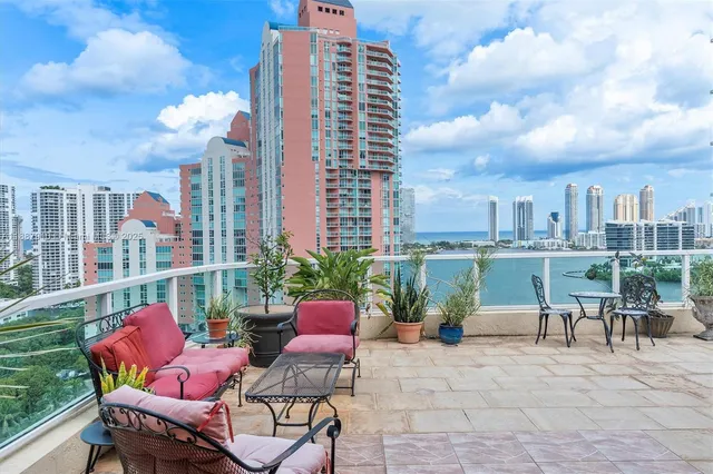 a view of a patio with couches and table and chairs and potted plants