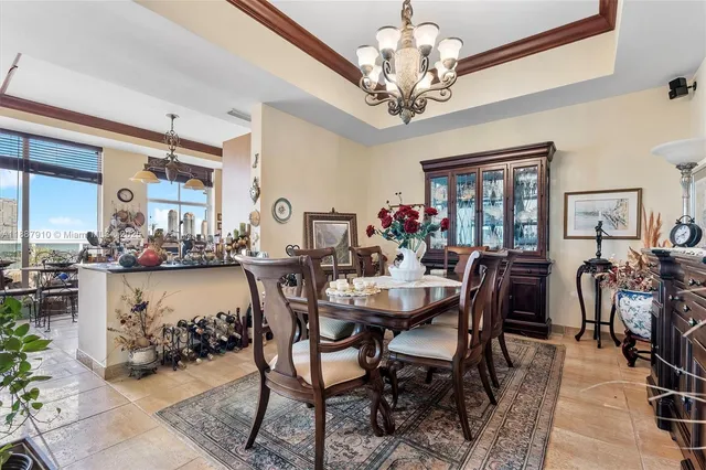 a view of a dining room with furniture and chandelier
