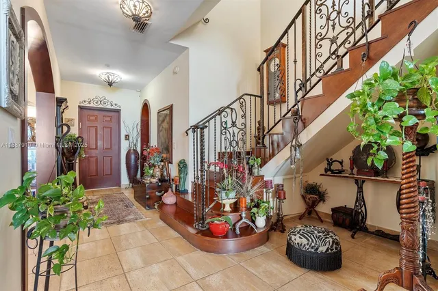 a view of entryway with lots of potted plants