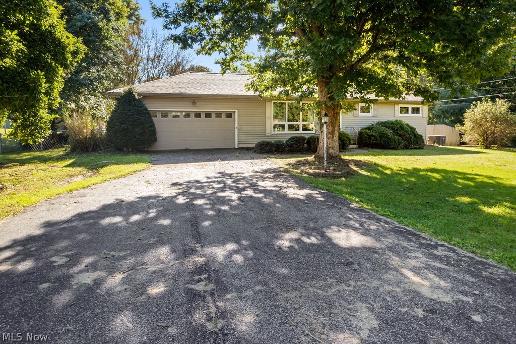 11363 Dupont Road Washington, WV 26181 - Photo 29 of 42 Single-story residence featuring a two-car garage, mature trees, and a sloped lawn