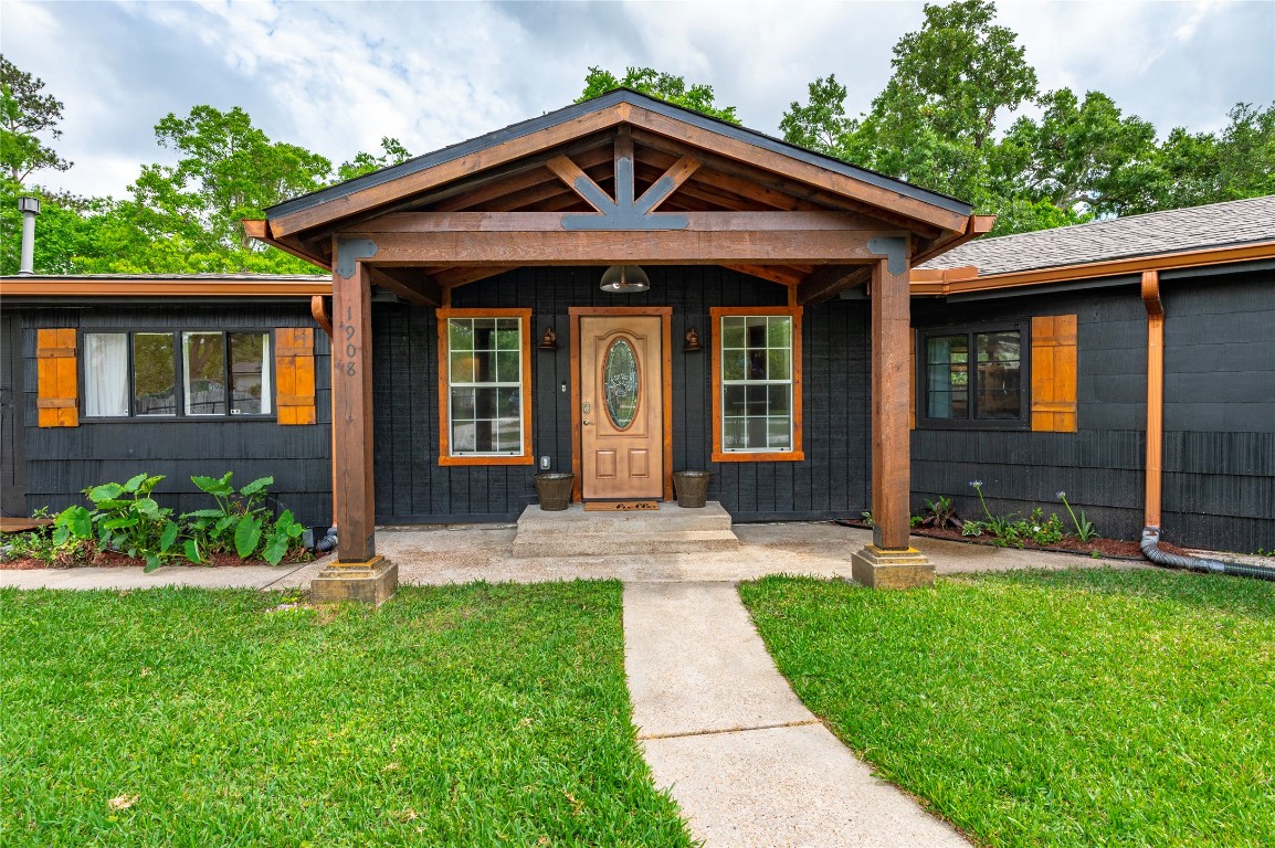 1908 Deats Road Dickinson, TX 77539 - Photo 1 of 41 Wood beam accented front porch and entryway to the home.