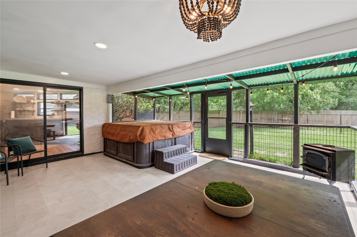 1908 Deats Road Dickinson, TX 77539 - Photo 15 of 41 Large enclosed patio with hot tub, hard floors and hanging light fixtures.