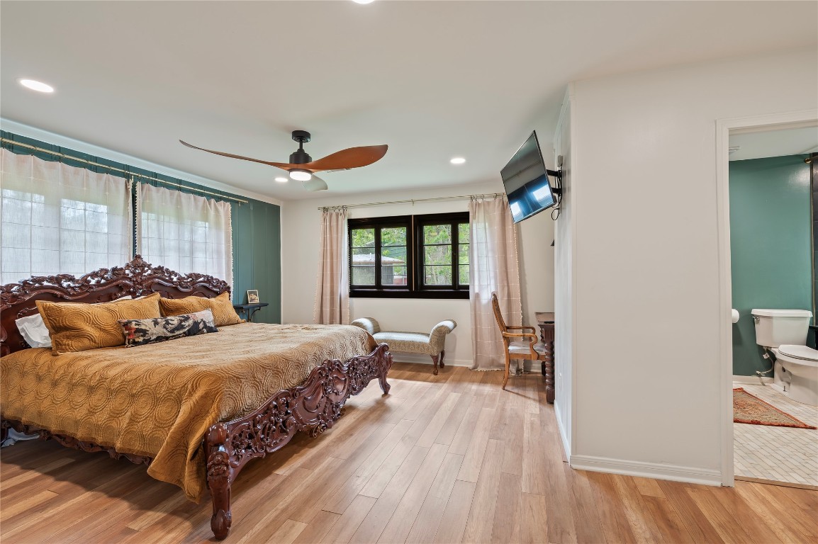 1908 Deats Road Dickinson, TX 77539 - Photo 17 of 41 Spacious primary bedroom with ceiling fan fixture and property views.