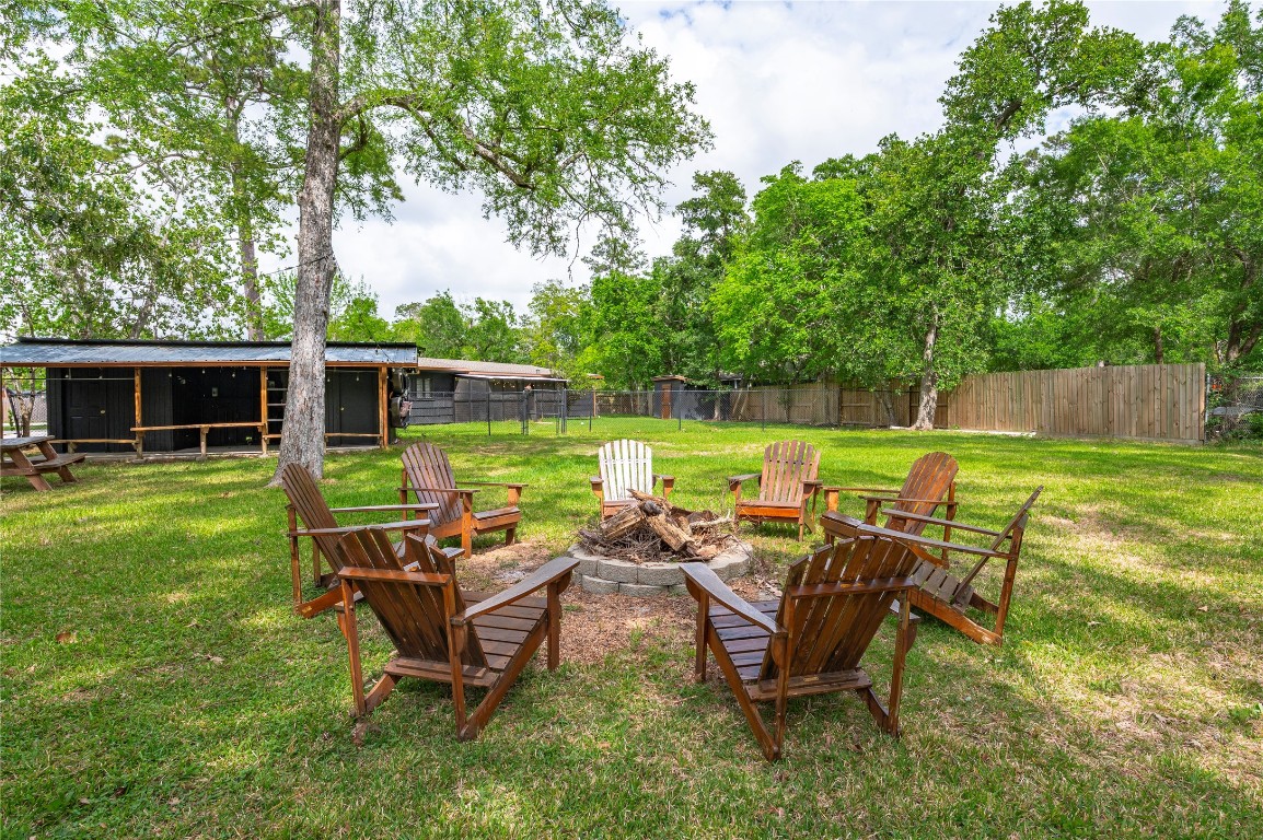 1908 Deats Road Dickinson, TX 77539 - Photo 28 of 41 Firepit circled by outdoor chairs looks back at the property.